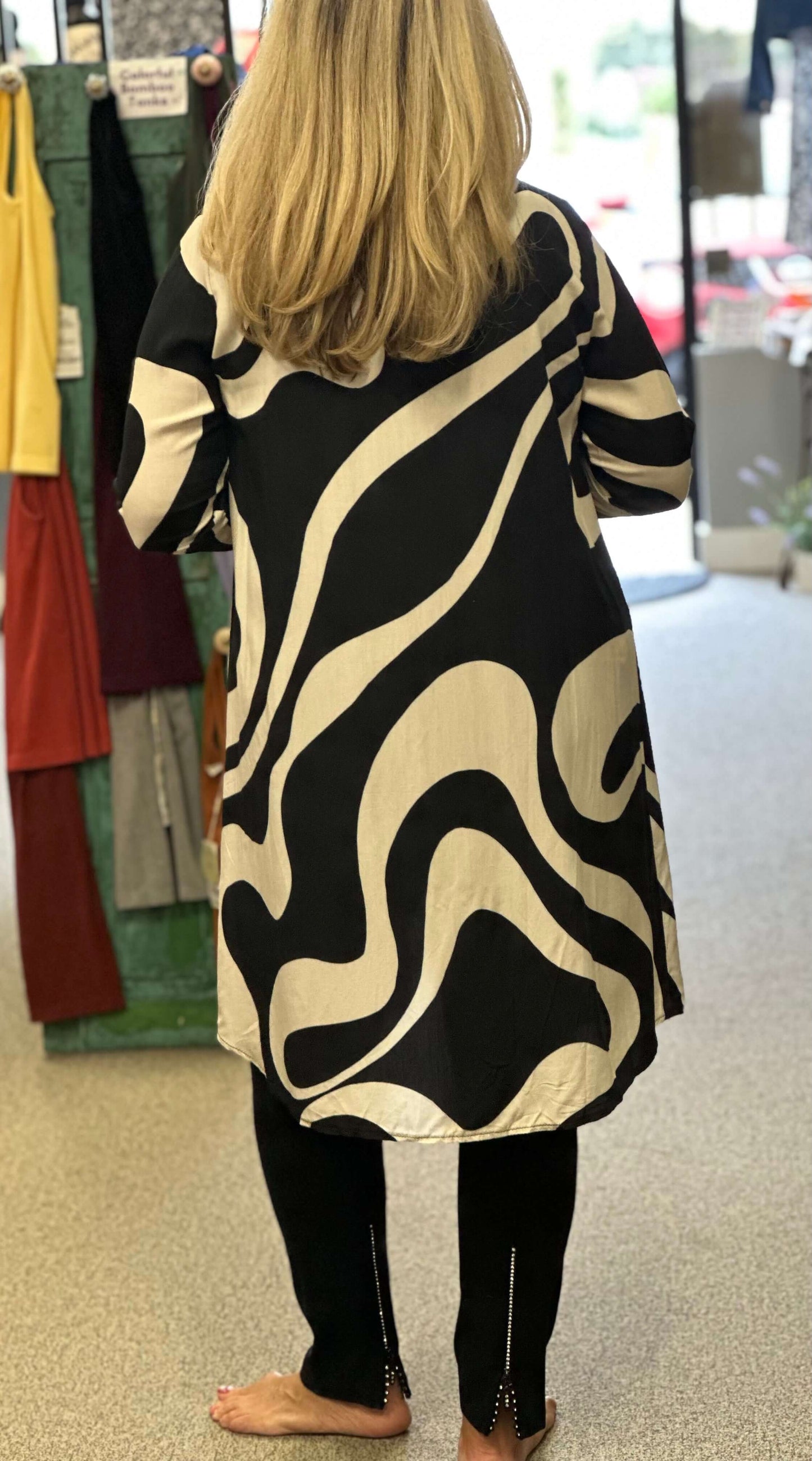 Two for one is what you'll get with this black combo top. You can wear it open as an over piece, button it up with leggings or wear it as a dress. Pick your pleasure.