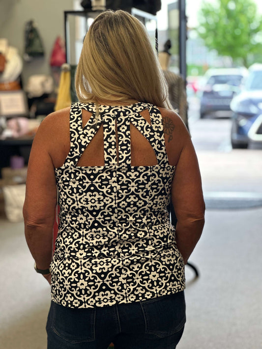 Sleeveless black and white print top with cutout design in the front and back. Sexy, stylish and classic wrapped up into one top.