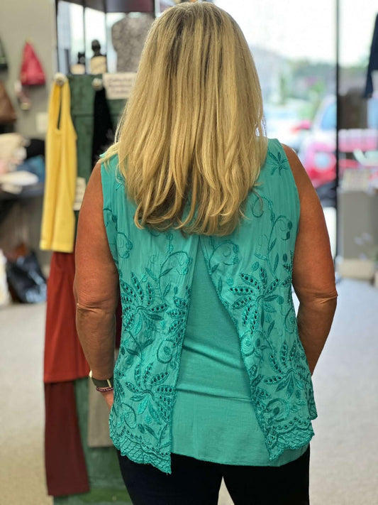 A beautiful eyelet sleeveless top with a cami underneath that is longer in length. Two perfect colors to choose from, which will go with everything.