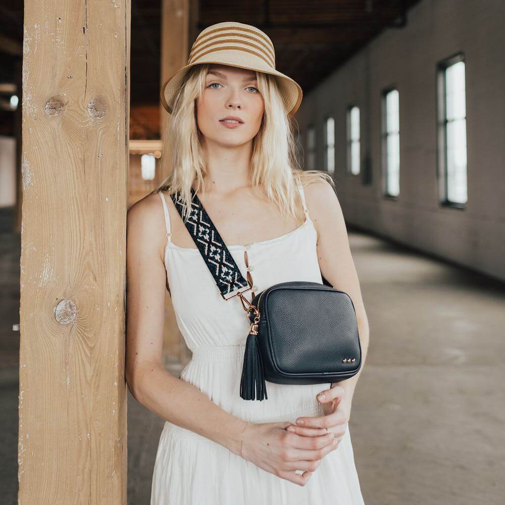 You are going to love this style. This is the perfect bag to hold all your things with a small front pocket for your smaller easy to reach items such as keys, lipgloss, hair ties, etc. The large side pocket has a chevron pattern, and an additional slash zipper pocket. The Austin Sling Bag has a removable woven floral guitar strap, and is a great bag for many occasions.