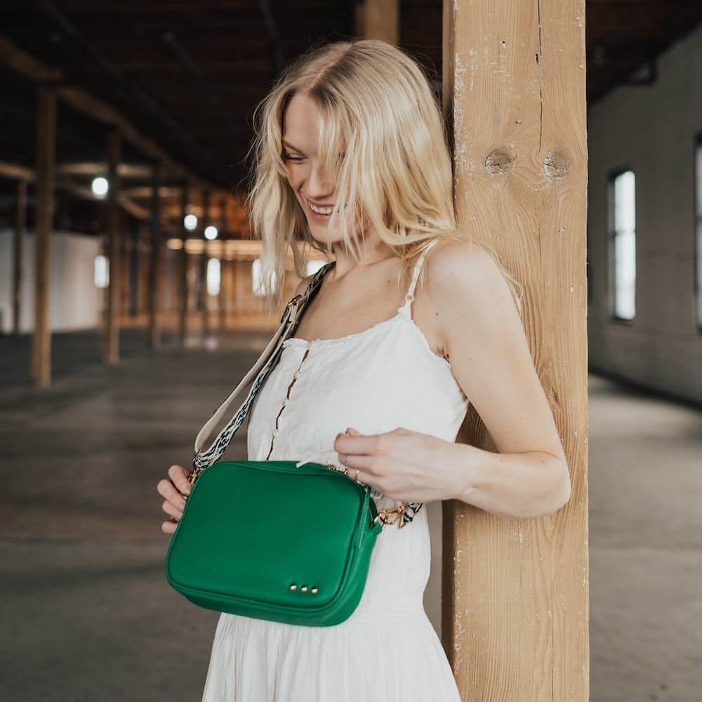 You are going to love this style. This is the perfect bag to hold all your things with a small front pocket for your smaller easy to reach items such as keys, lipgloss, hair ties, etc. The large side pocket has a chevron pattern, and an additional slash zipper pocket. The Austin Sling Bag has a removable woven floral guitar strap, and is a great bag for many occasions.