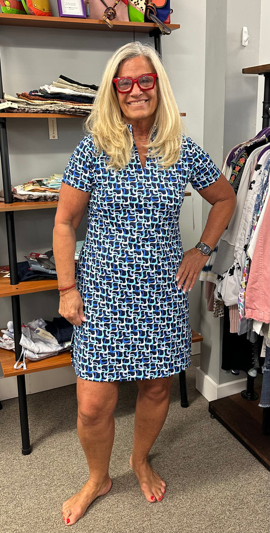 This short sleeve dress has a slit v-neck and slits on the side. Vibrant colors of navy, turquoise, white and periwinkle.