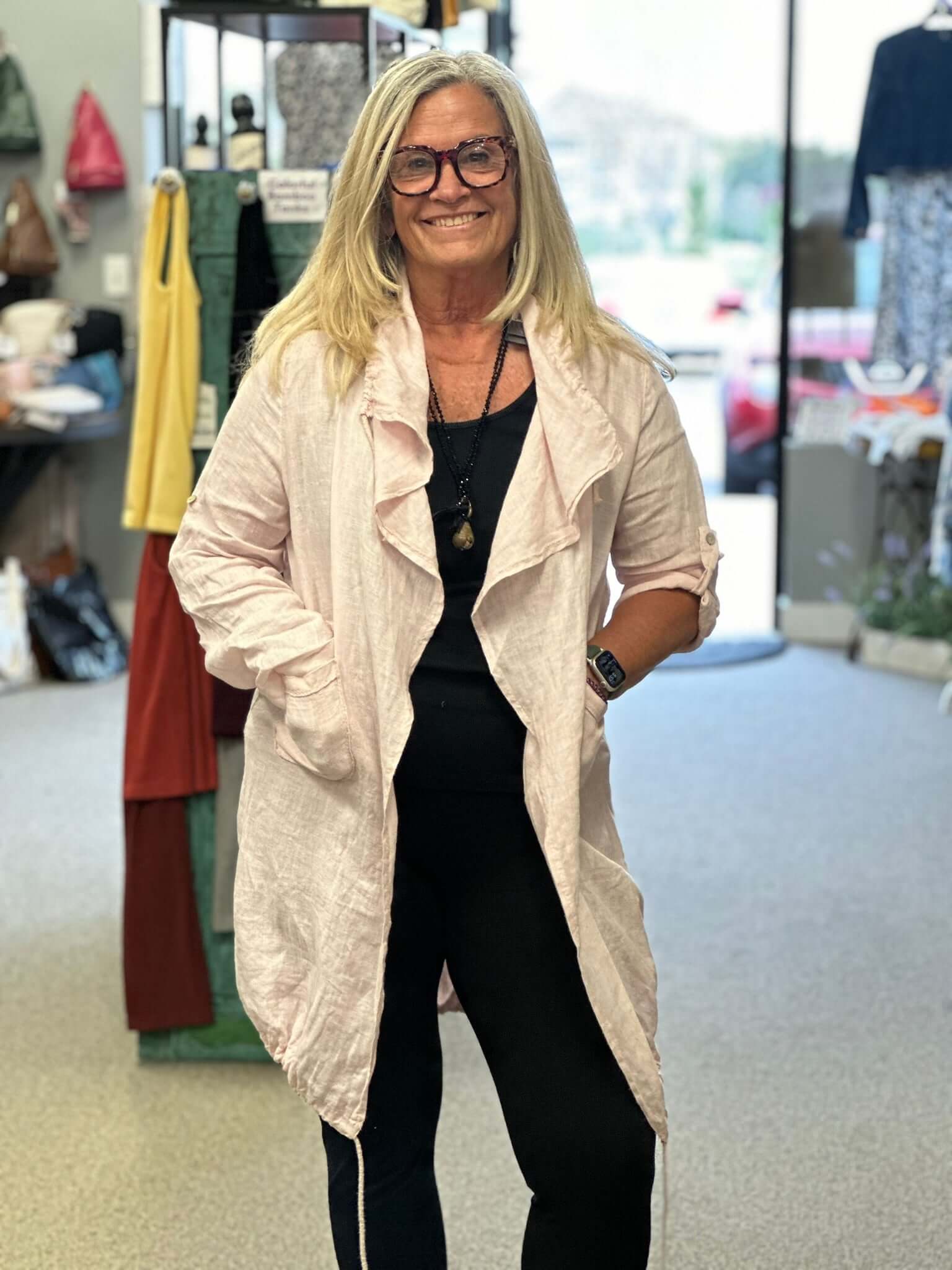 A perfect over-piece all year round with this linen duster. Drawstring collar that cascades down the front and adjustable hemline, front pockets, along with adjustable sleeves, that you can roll up or wear as a long sleeve, with a button.