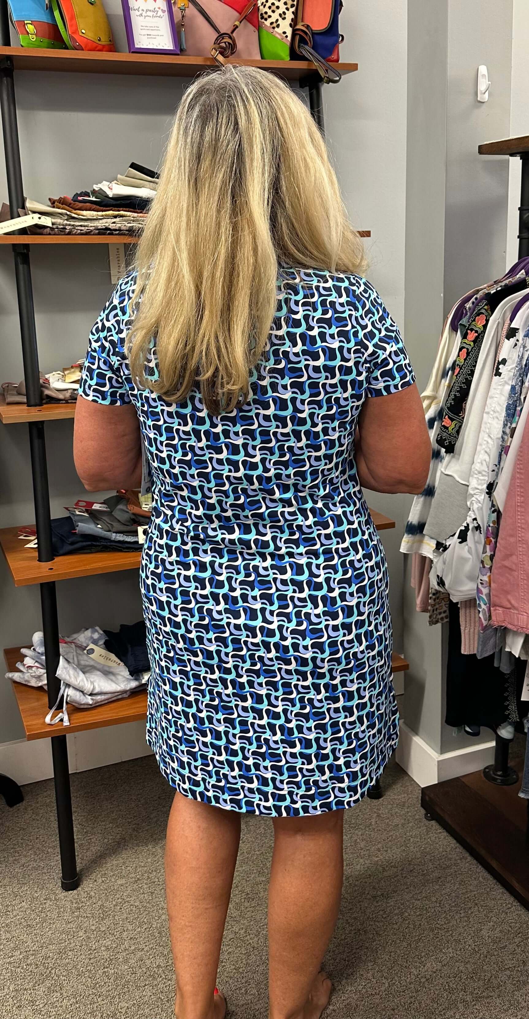 This short sleeve dress has a slit v-neck and slits on the side. Vibrant colors of navy, turquoise, white and periwinkle.