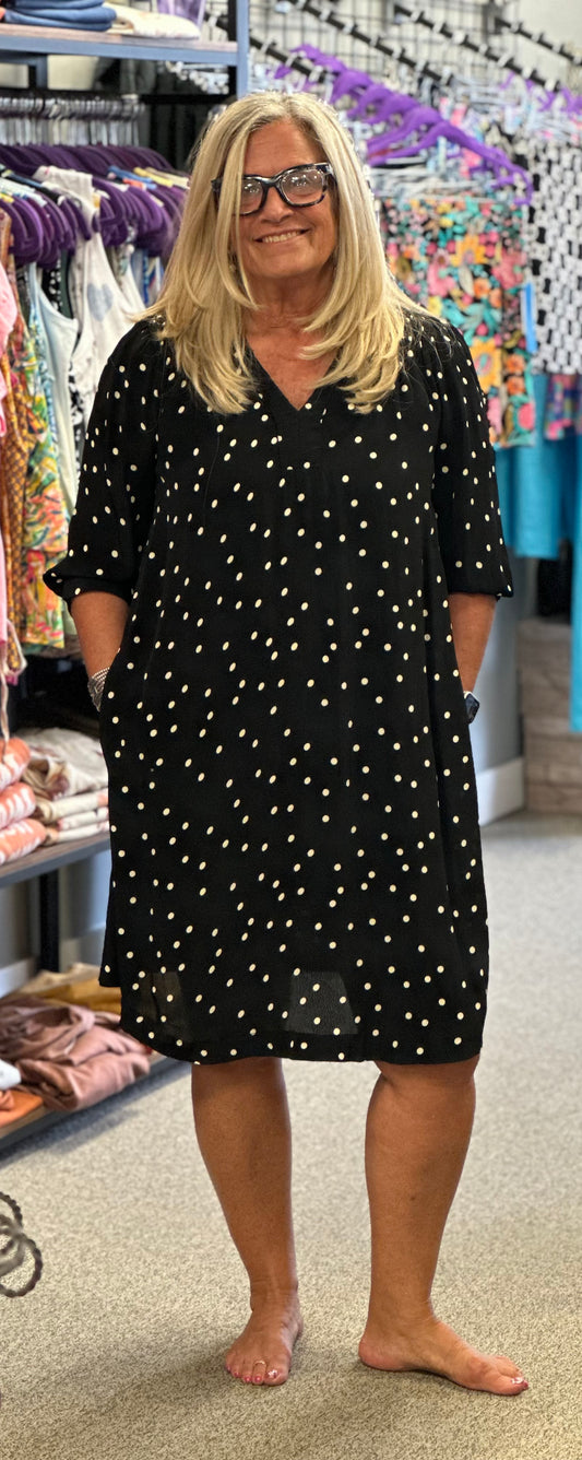 Love this dress. Its black with tan polka dots, pockers, 3/4 sleeve with a little ruching at the top of the v-neck.
