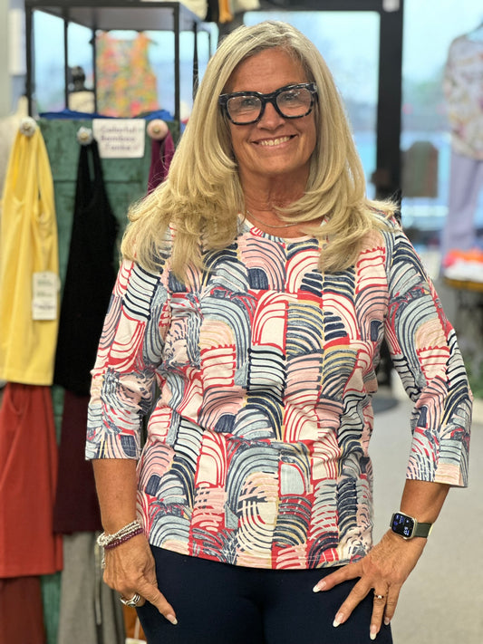 This top has an array of red, blue, white and a little pink. Its round neck and 3/4 sleeve make it perfect for morning, noon or night.