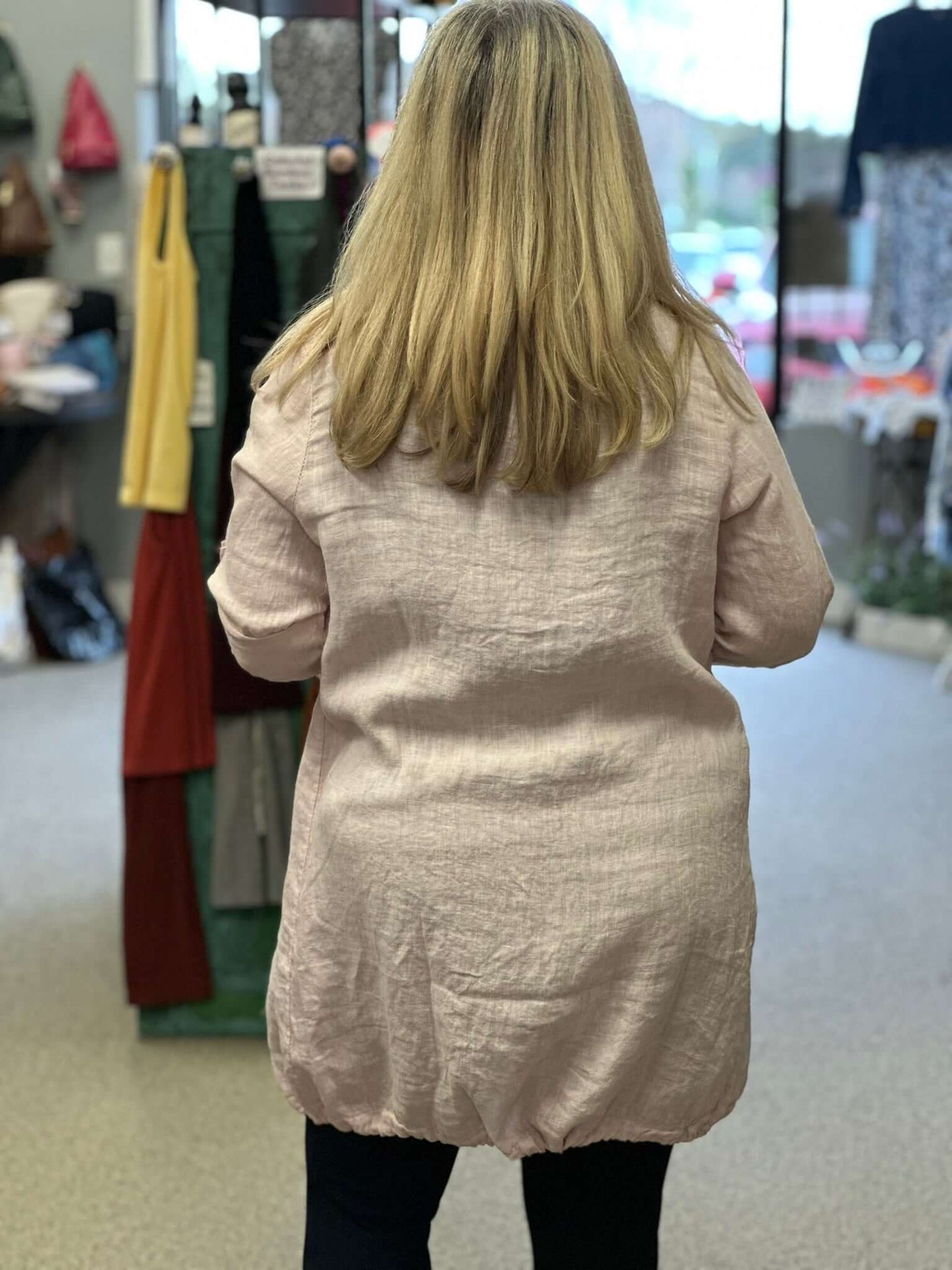 A perfect over-piece all year round with this linen duster. Drawstring collar that cascades down the front and adjustable hemline, front pockets, along with adjustable sleeves, that you can roll up or wear as a long sleeve, with a button.