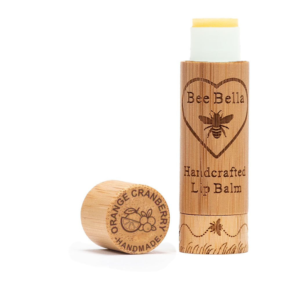 Bee Bella lip balm with wooden container on a white background